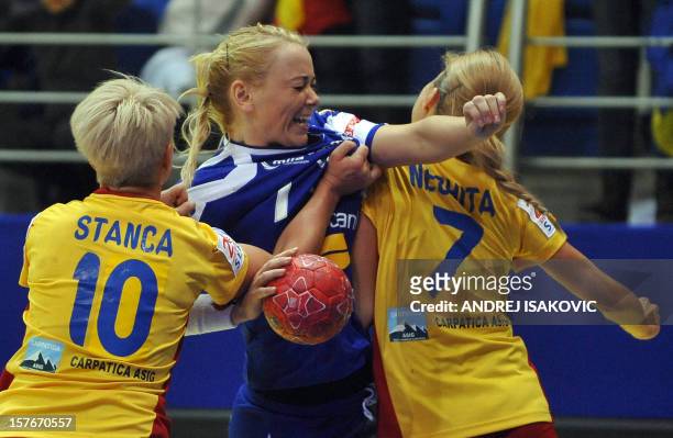 Iceland's Rakel Dogg Brafadottir vies with Romania's Ionela Stanca and Adriana Nicoleta Nechita during the Women's EHF Euro 2012 Handball...