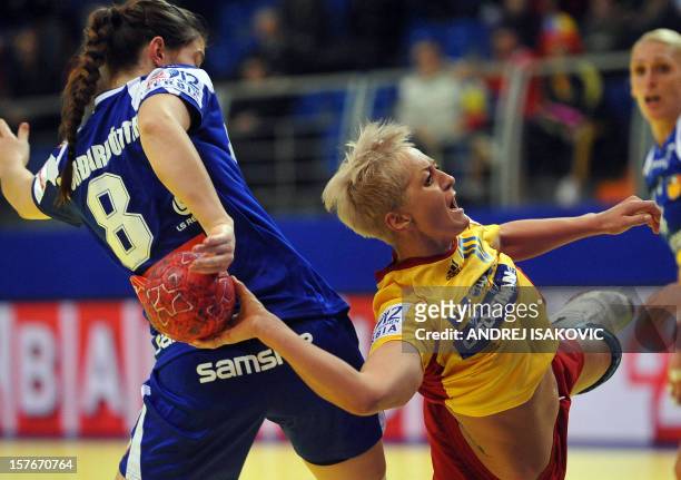 Romania's Ionela Stanca vies with Iceland's Stella Sigurdardottir during the Women's EHF Euro 2012 Handball championship match Iceland vs Romania on...