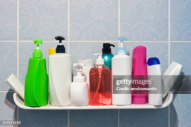 many shampoo and soap bottles on a bathroom shelf. - bottle bildbanksfoton och bilder