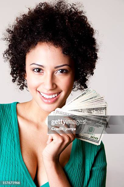 young woman holding fanned out 100 dollar bills - money talks stock pictures, royalty-free photos & images