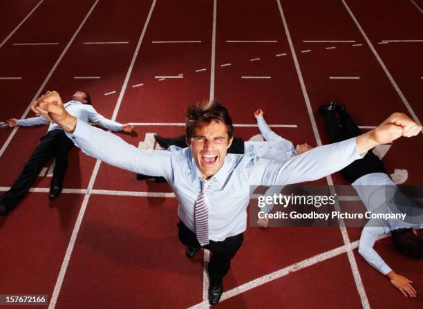 joyful middle aged executive winning a business race - overthrow stock pictures, royalty-free photos & images