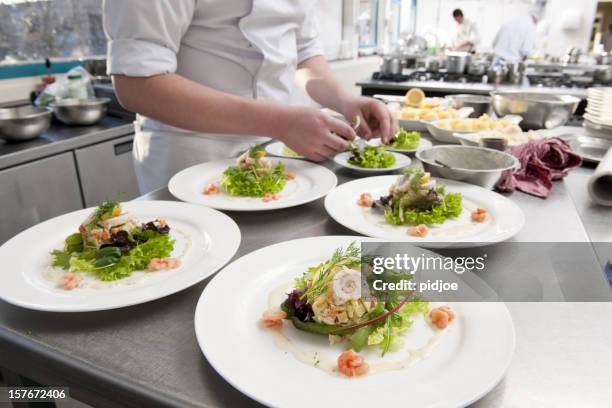 chef preparing white plates with seafood salad - seafood salad stock pictures, royalty-free photos & images