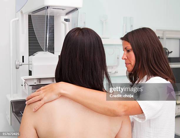 nurse with young women having a mammogram - medical x ray stock pictures, royalty-free photos & images
