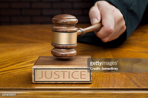 judge's hand pounding gavel to end courtroom trial - crime suppression stock pictures, royalty-free photos & images