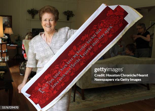 Lee Hunnell, President of Saintly Stitchers, holds a completed kneeler by Patricia McCulloch of Hoboken, N.J., on April 21 in Houston, Tx.