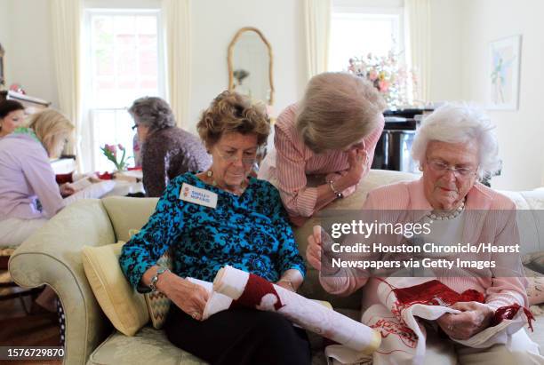 Shirley Hopkins sits next to the Former First Lady Barbara Bush while talking with Gerry Eversole stitching kneelers with the Episcopalian Saintly...