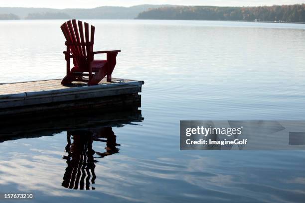 adirondack chair by a lake - muskoka stock pictures, royalty-free photos & images