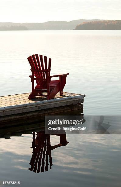 adirondack chair by the lake - muskoka stock pictures, royalty-free photos & images