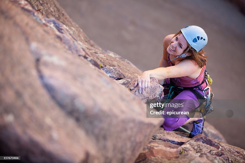 Young woman leading a climbing route in Colorado