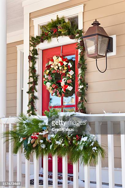 snow on porch with christmas decorations - colonnade residences stock pictures, royalty-free photos & images