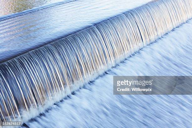 waterfall water over dam from tranquil calm to rushing blur - flowing water abstract stock pictures, royalty-free photos & images