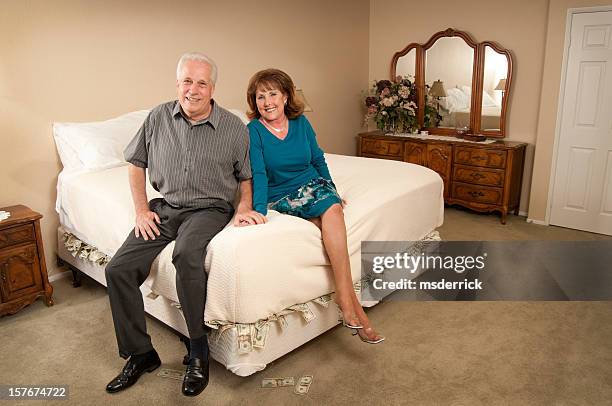 money under mattress couple - hiding money stock pictures, royalty-free photos & images