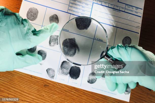 forensic scientists compare crime scene fingerprints for clues - murder case stock pictures, royalty-free photos & images