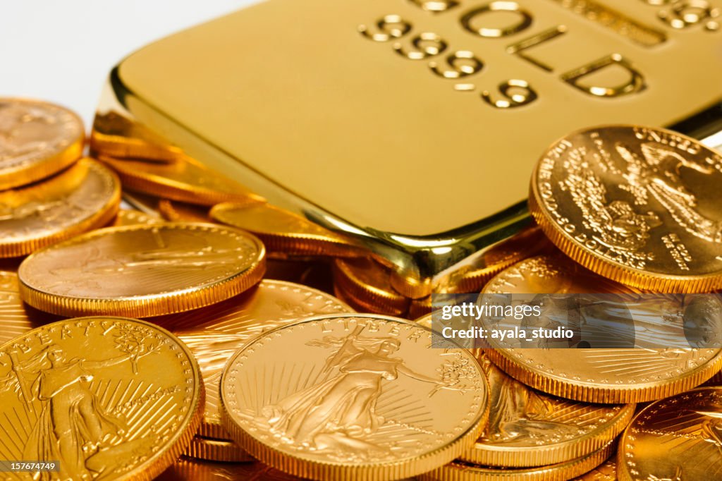 Gold ingot surrounded by golden coins