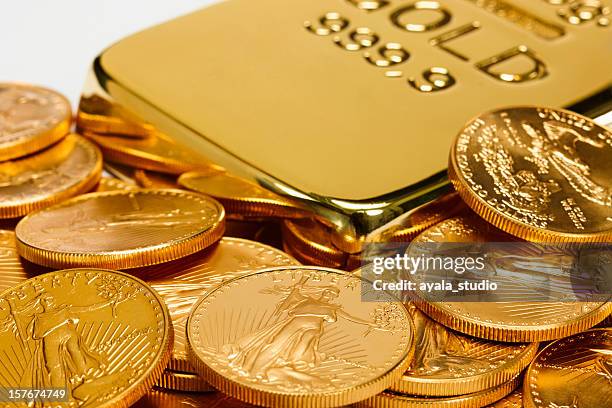 gold ingot surrounded by golden coins - guldtacka bildbanksfoton och bilder