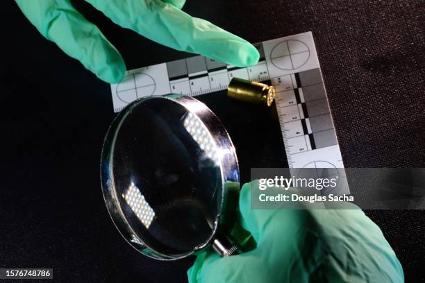 bullet casing on a crime scene - shooting bullet casing stock pictures, royalty-free photos & images