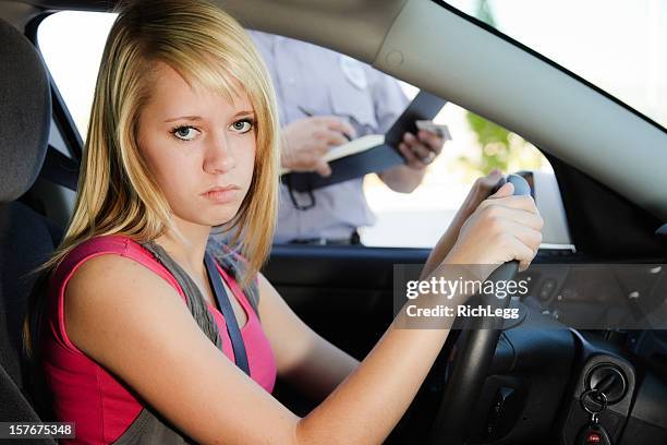 teenage girl receiving a ticket - teen arrest stock pictures, royalty-free photos & images