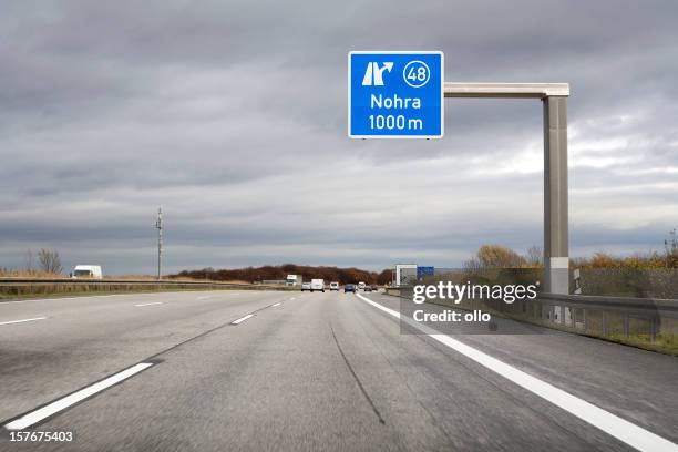 road sign on german autobahn - next exit nohra - autobahn stock pictures, royalty-free photos & images