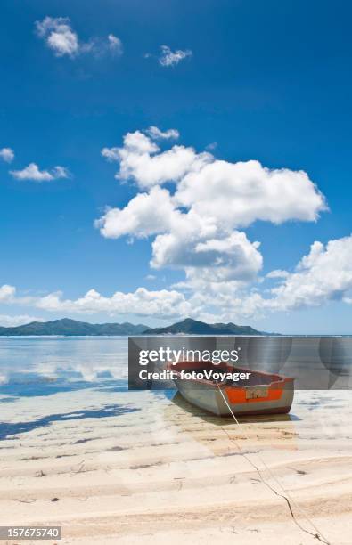island beach tropical shore colorful boat ocean lagoon seychelles - praslin island stock pictures, royalty-free photos & images