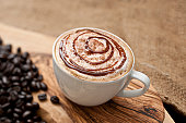 Cappuccino topped with swirls of chocolate sauce