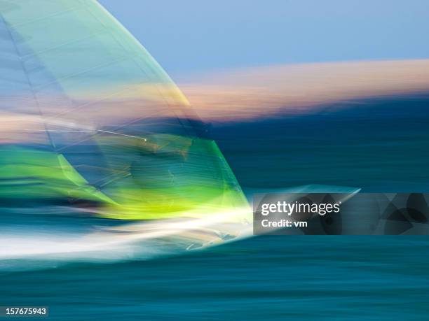 panning shot of windsurfer - wind surfing stock pictures, royalty-free photos & images