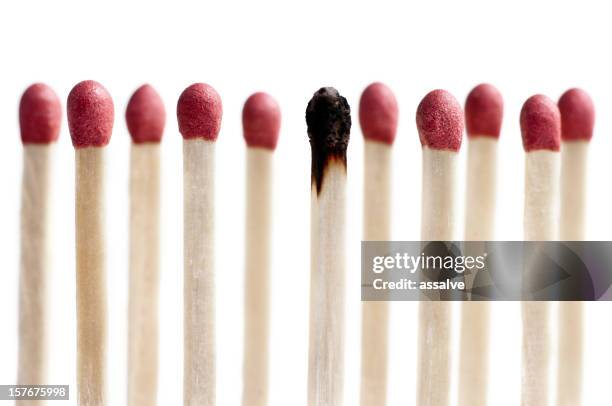 eleven matchsticks standing in a row one burned - burnt matchstick stock pictures, royalty-free photos & images