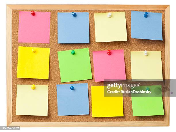 office cork board full of colored memo notes. - cork board stock pictures, royalty-free photos & images