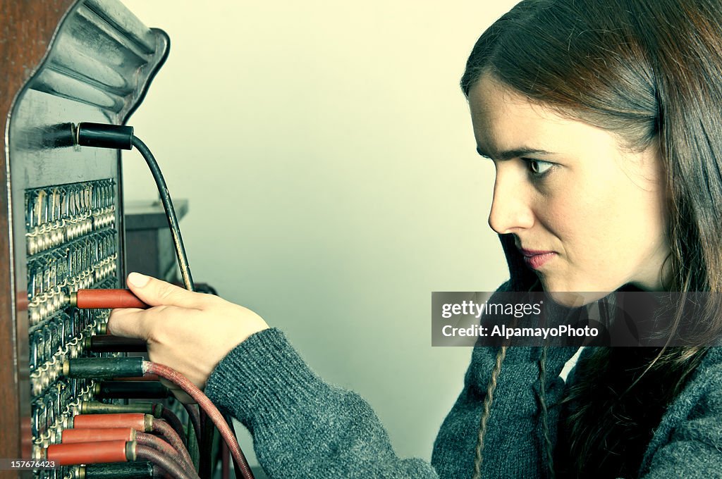 Telephone operator with outdated tele-communication technology (retro) - I