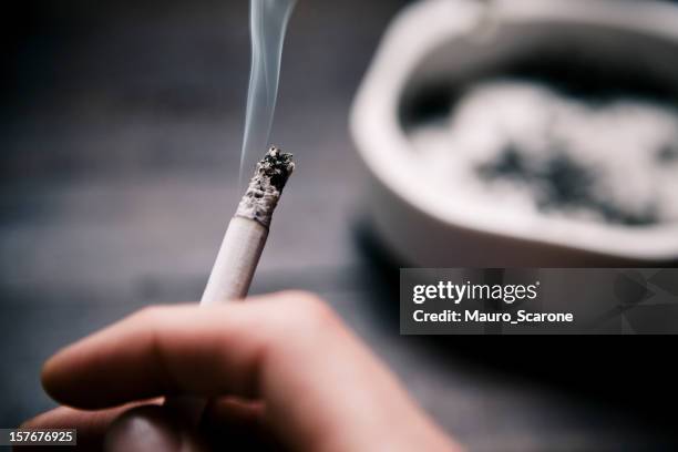 holding a cigarette. - ashtray stock pictures, royalty-free photos & images