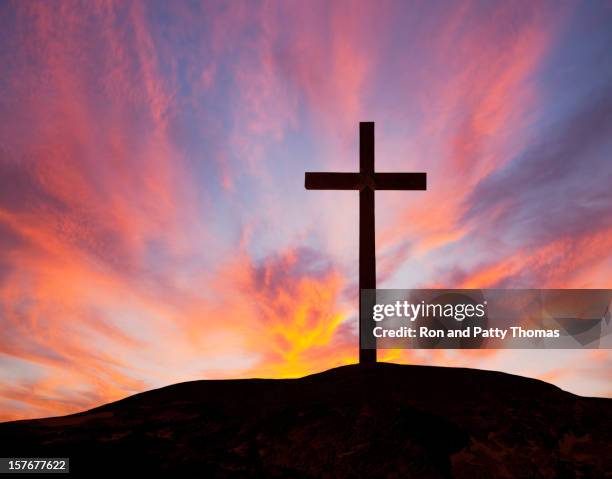 silhouette of a wooden cross on a hill with a sunset - cross stock pictures, royalty-free photos & images