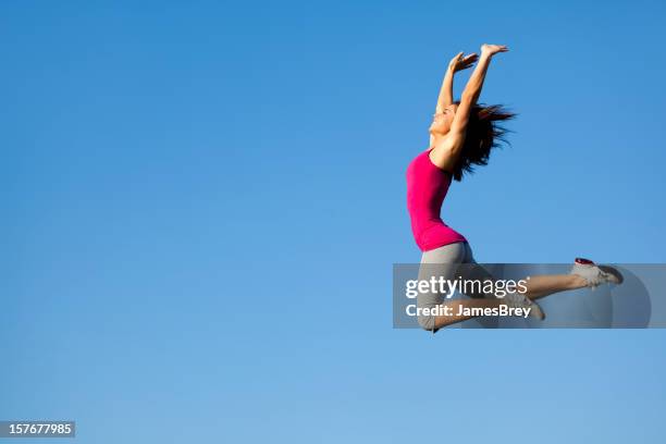 athletic girl jumps high in the sky - james hale stock pictures, royalty-free photos & images