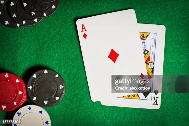 poker table with gambling chips and two cards - blackjacks stock pictures, royalty-free photos & images