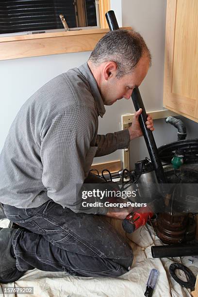 plumber working - water pump stock pictures, royalty-free photos & images