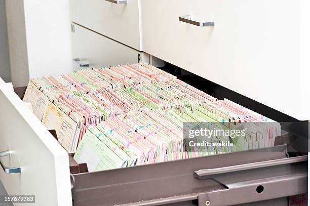 patient documents in drawer - medical record - filing cabinet stock pictures, royalty-free photos & images