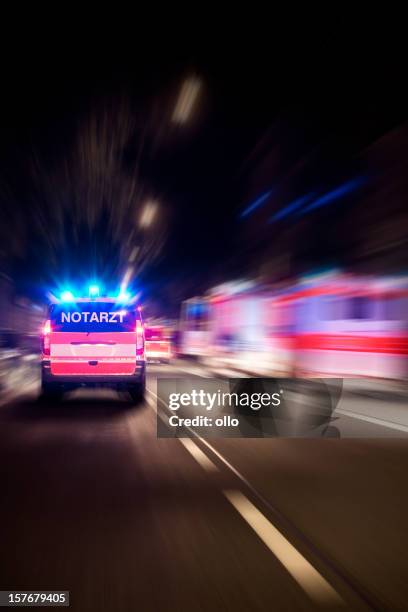 arriving german emergency ambulance, motion blur - ambulance stockfoto's en -beelden