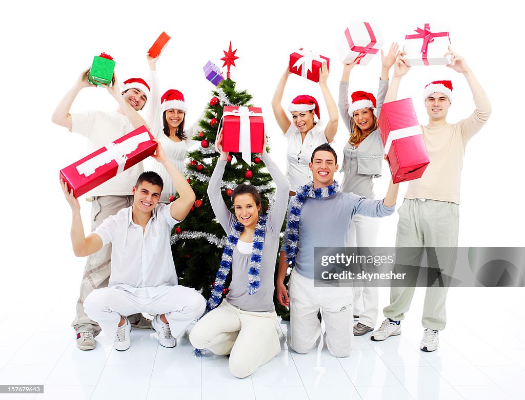 Group of a happy people holding many Christmas gift.