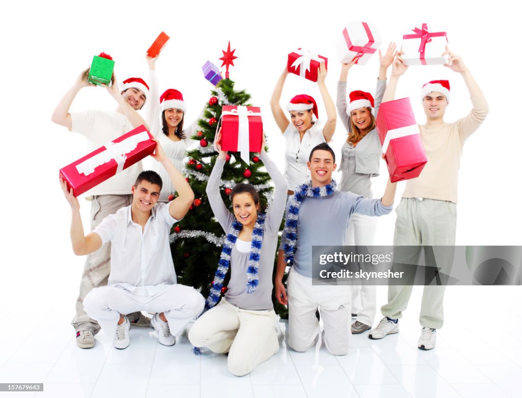 Group of a happy people holding many Christmas gift.