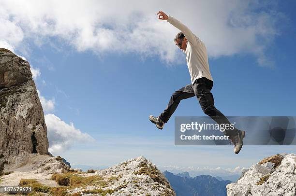 alpinist jumping over the precipice - ravine stock pictures, royalty-free photos & images