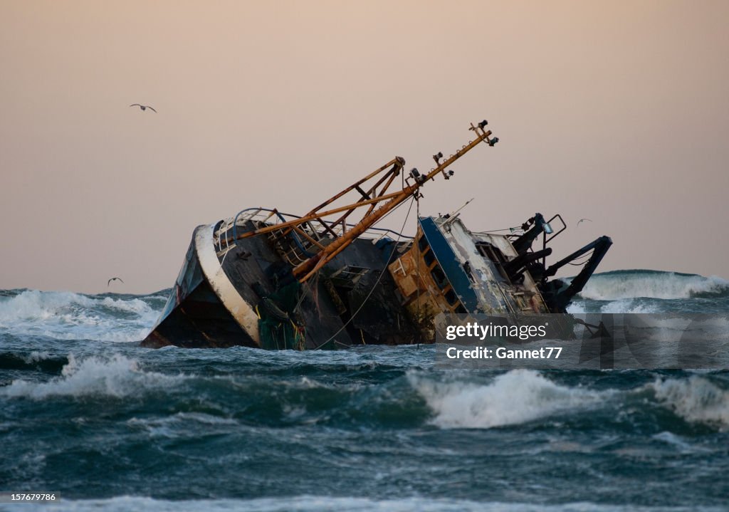 Fishing vessel boat aground on sea