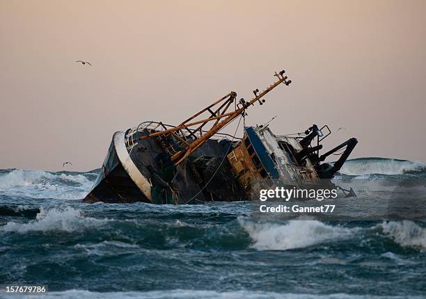 fishing vessel boat aground on sea - shipwreck stock pictures, royalty-free photos & images