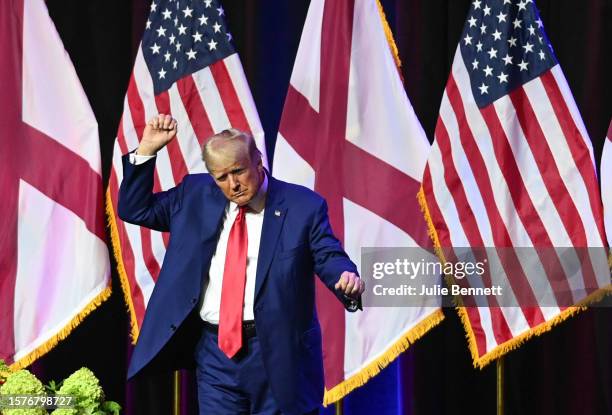 Former U.S. President Donald Trump dances on stage after speaking during the Alabama Republican Party’s 2023 Summer meeting at the Renaissance...