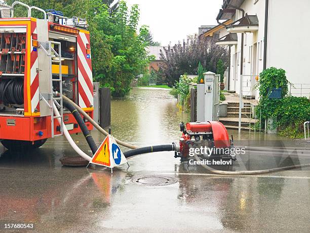 fire engine at work pumping water - water slovenia stock pictures, royalty-free photos & images