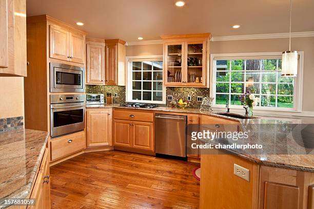 modern, spacious kitchen with hardwood floors and cabinets - wooden cabinet stock pictures, royalty-free photos & images