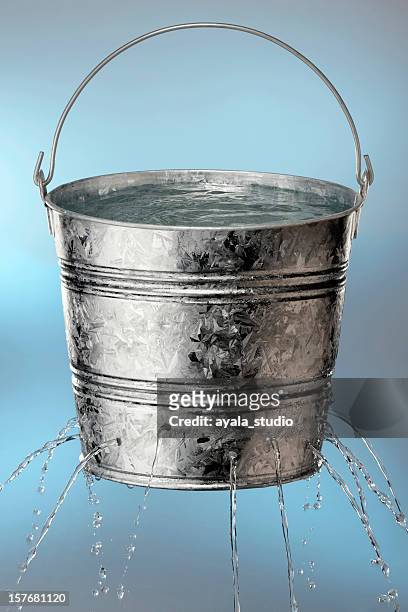 bucket with holes leaking water - bucket stock pictures, royalty-free photos & images