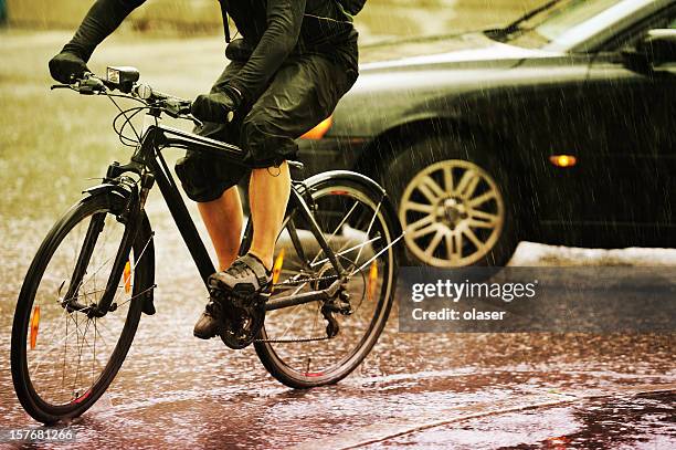 junger erwachsener auf fahrrad in die stadt, regnerischen abend-verkehr - reflector stock-fotos und bilder