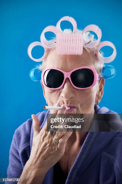 senior woman with curlers - funny cigarette stock pictures, royalty-free photos & images