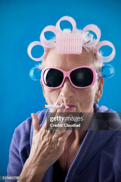 senior woman with curlers - woman smoking stock pictures, royalty-free photos & images