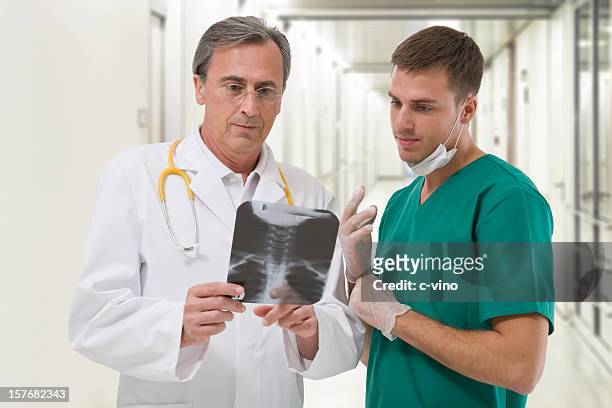 two surgeons checking a radiography - intervertebral discs stock pictures, royalty-free photos & images