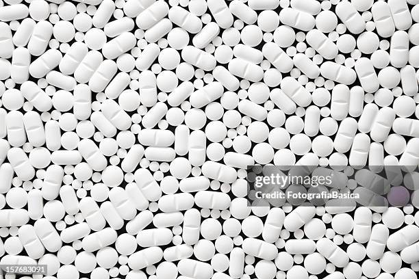 lots of white pills - pill background stock pictures, royalty-free photos & images