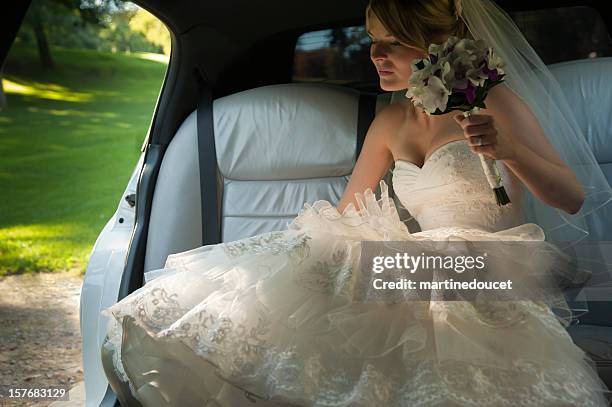 young bride going out the limousine - wedding limousine stock pictures, royalty-free photos & images